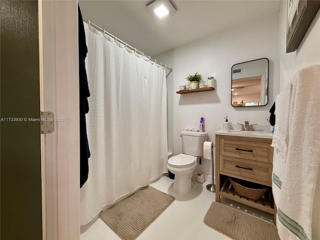 bathroom featuring vanity, toilet, and tile patterned flooring