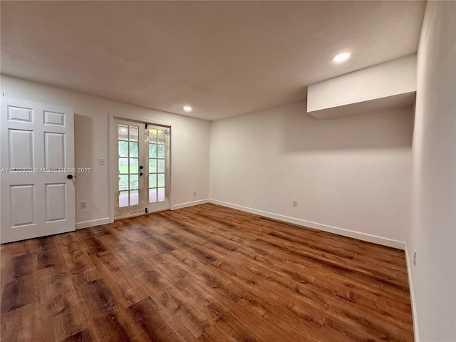 empty room featuring french doors and hardwood / wood-style floors