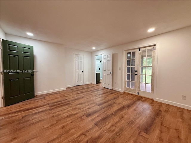 unfurnished room with wood-type flooring and french doors