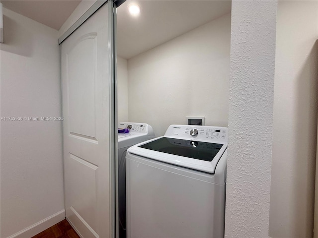 laundry room with dark hardwood / wood-style floors and washing machine and dryer