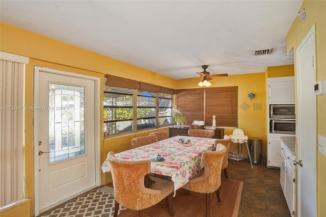 dining room featuring dark tile patterned flooring