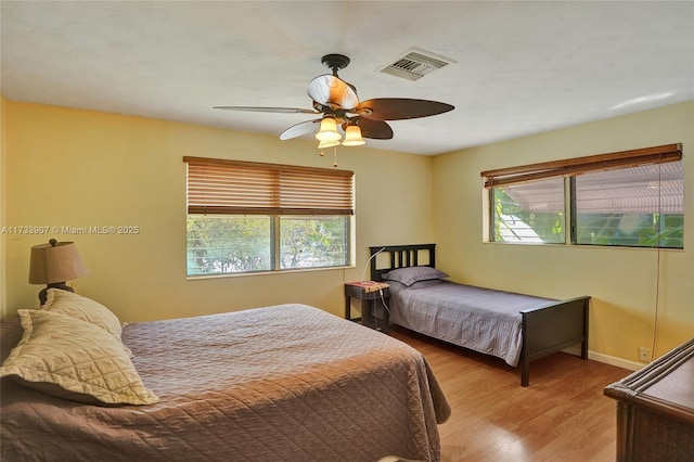 bedroom with ceiling fan and light hardwood / wood-style flooring