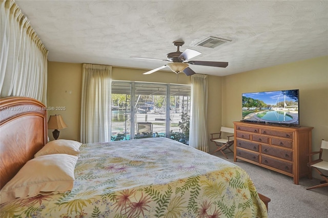 carpeted bedroom featuring ceiling fan, a textured ceiling, and access to outside