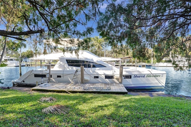 dock area featuring a water view and a lawn