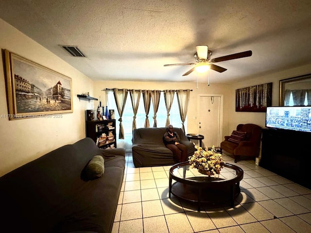 tiled living room featuring ceiling fan and a textured ceiling