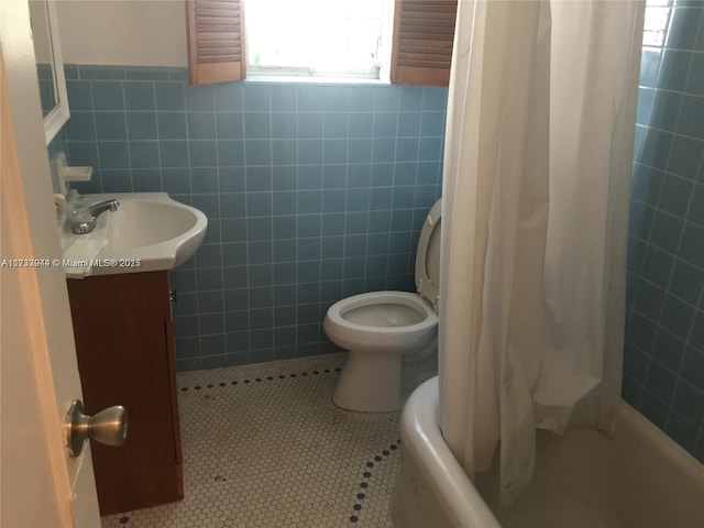 full bathroom featuring tile walls, tile patterned flooring, vanity, toilet, and shower / bath combo with shower curtain