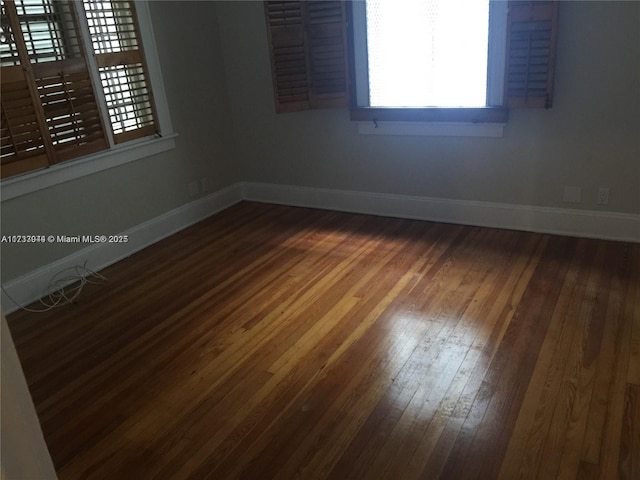 unfurnished room with wood-type flooring