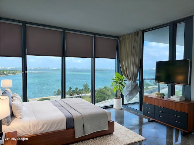 tiled bedroom featuring a water view and floor to ceiling windows