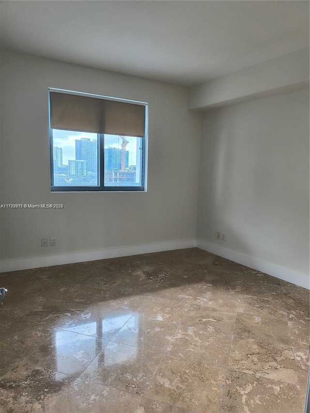 empty room featuring baseboards