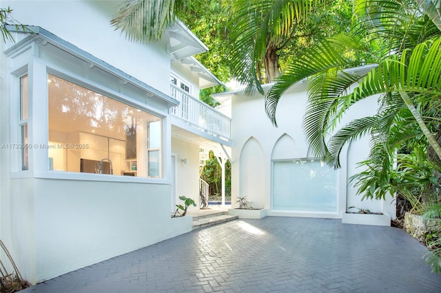 view of front of house featuring a balcony