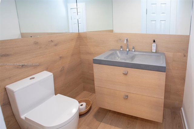 bathroom featuring hardwood / wood-style flooring, vanity, and toilet