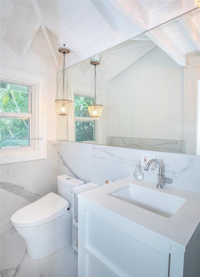 bathroom featuring vanity, tile walls, beam ceiling, and toilet