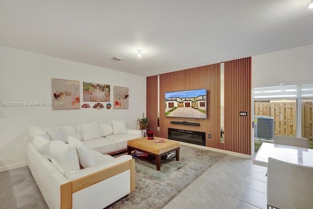 tiled living room featuring wooden walls