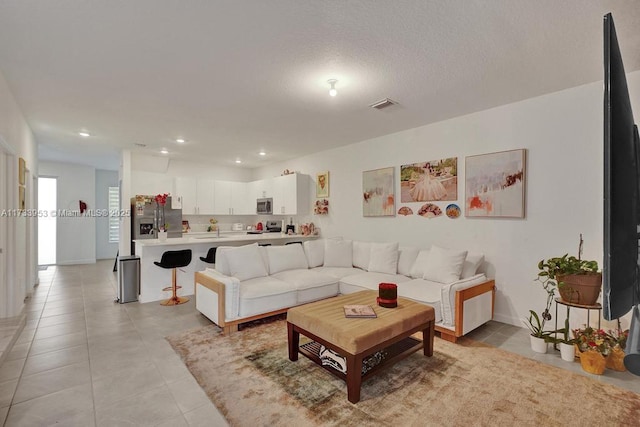 living room with light tile patterned flooring