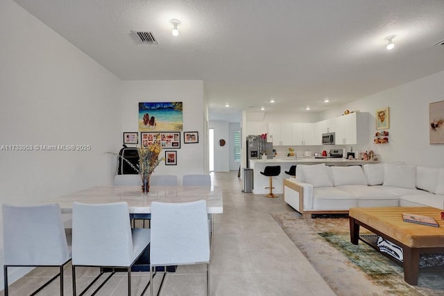 tiled living room with a textured ceiling