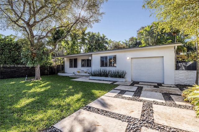 ranch-style home with a garage and a front yard