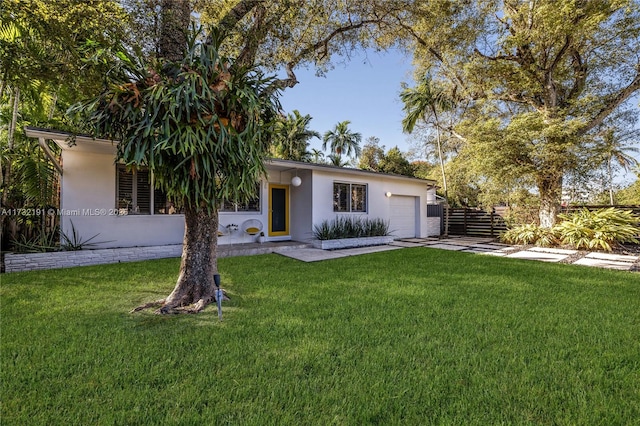 view of front of house with a garage and a front yard