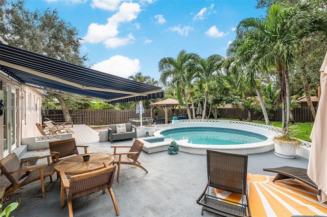 view of pool with an outdoor living space, a patio area, and a jacuzzi