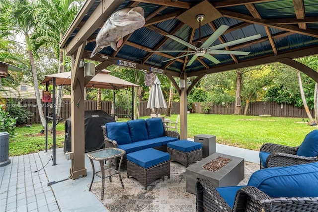 view of patio featuring a gazebo, ceiling fan, a grill, and an outdoor living space with a fire pit