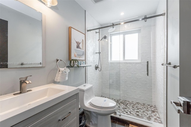 bathroom with vanity, toilet, and walk in shower