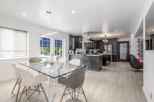 dining area featuring sink and light hardwood / wood-style flooring