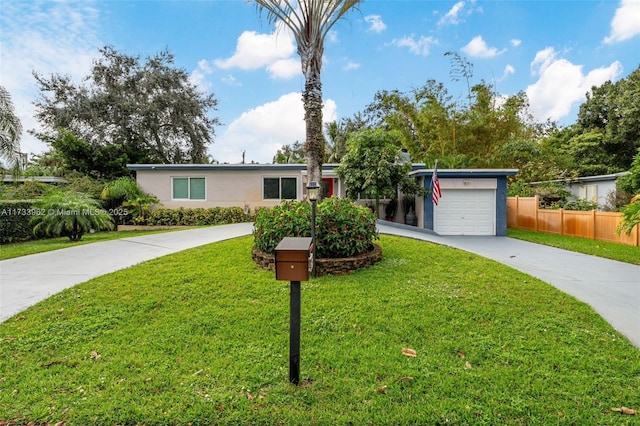 single story home featuring a garage and a front lawn