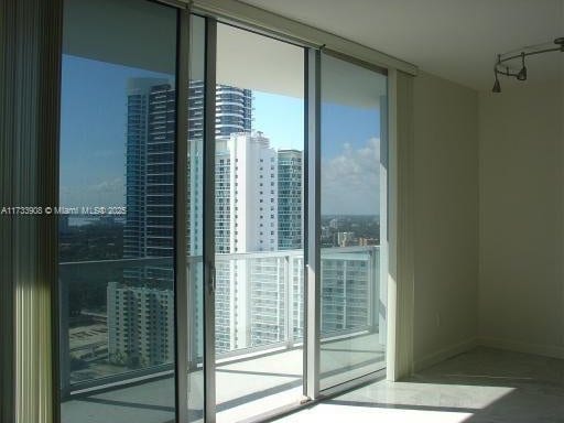 unfurnished room featuring floor to ceiling windows