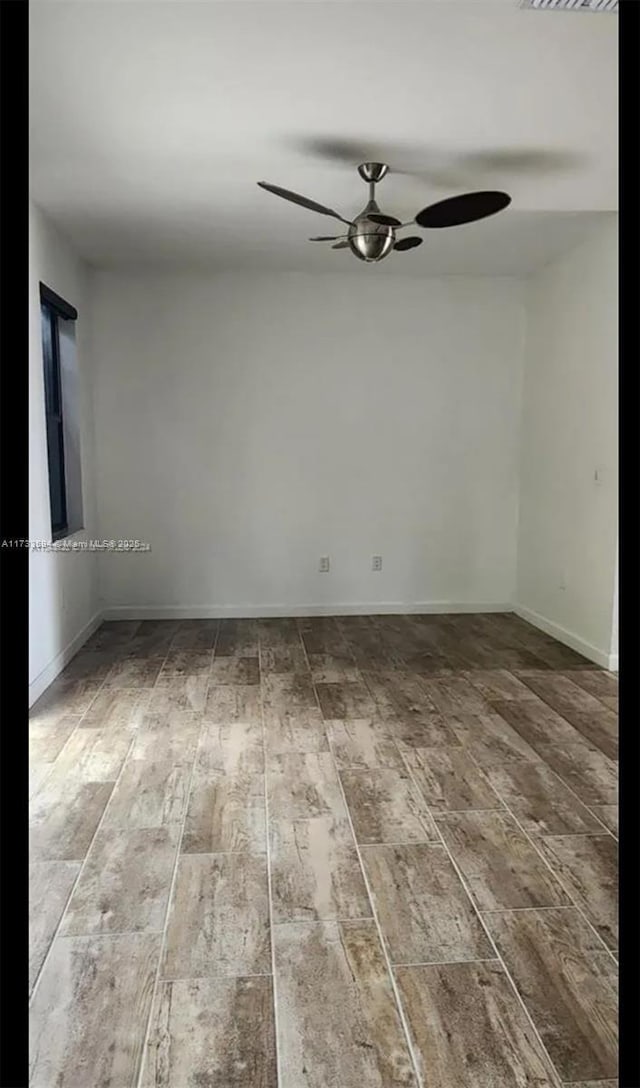 empty room with wood-type flooring and ceiling fan