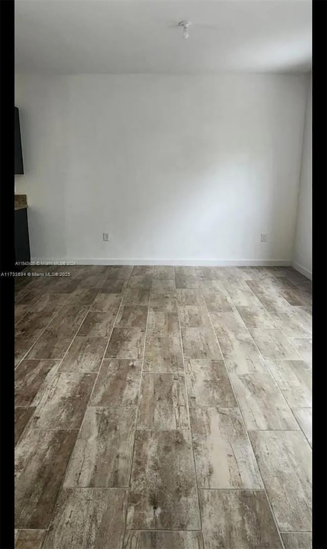 unfurnished room featuring hardwood / wood-style floors