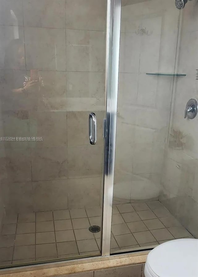 bathroom with an enclosed shower and toilet