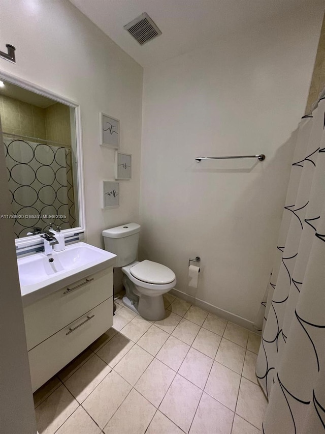 bathroom with a shower with curtain, tile patterned floors, vanity, and toilet