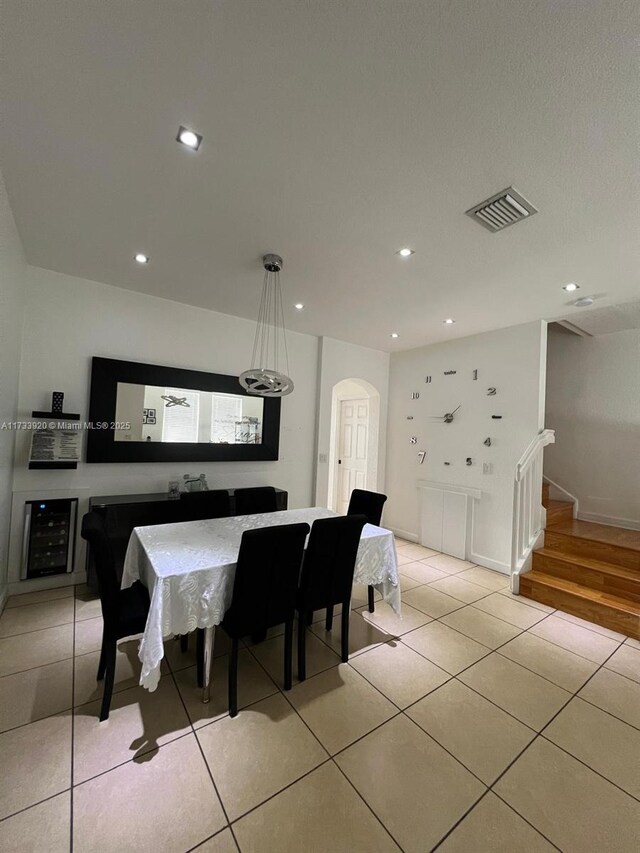 dining area featuring light tile patterned floors and beverage cooler