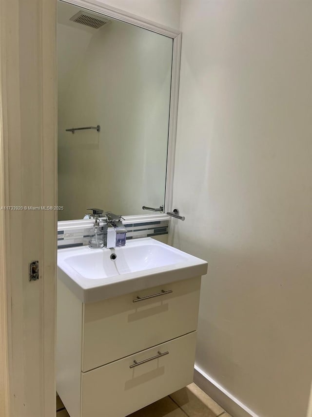 bathroom featuring tile patterned flooring and vanity