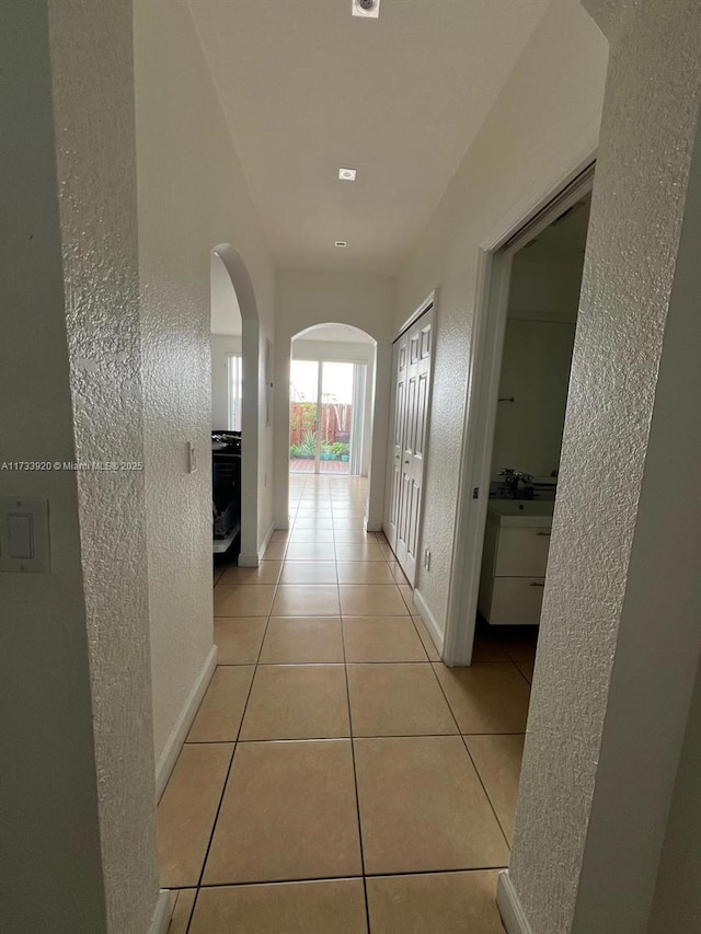 corridor featuring light tile patterned floors