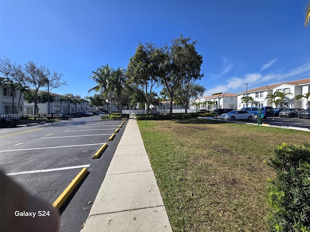 view of vehicle parking with a yard