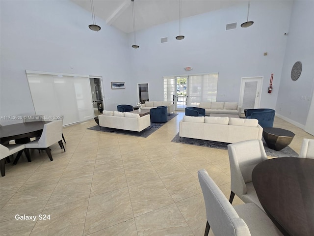 tiled living room with a towering ceiling and beam ceiling