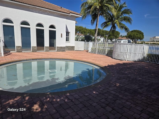 view of swimming pool with a patio