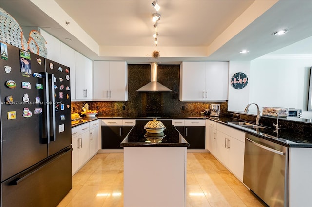 kitchen with a kitchen island, black refrigerator, dishwasher, sink, and wall chimney exhaust hood