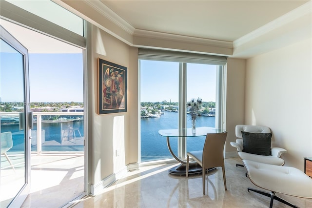 sitting room featuring ornamental molding and a water view