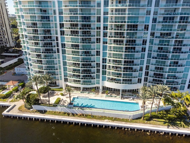 view of property with a water view and a community pool