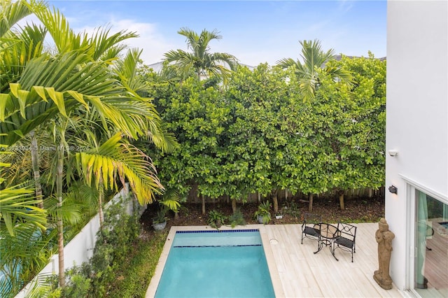 view of swimming pool with a wooden deck