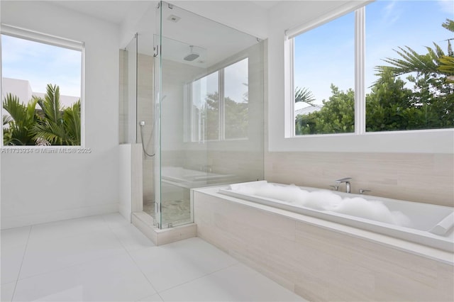 bathroom featuring tile patterned flooring, plus walk in shower, and a wealth of natural light