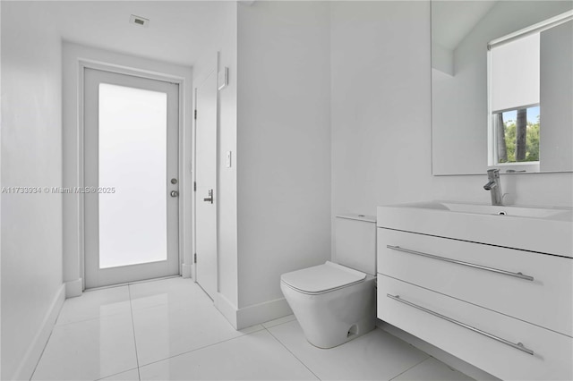 bathroom with vanity, tile patterned floors, and toilet