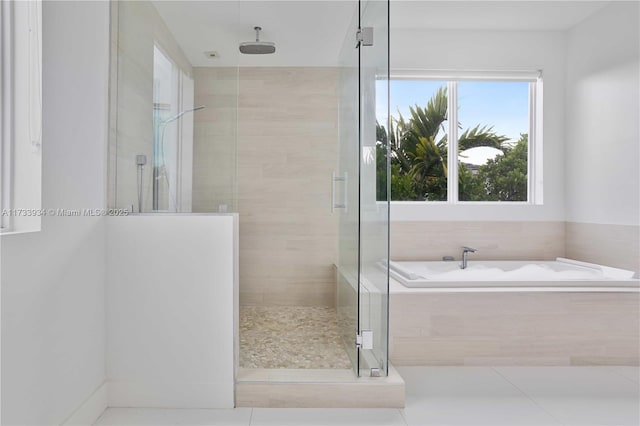 bathroom with tile patterned floors and separate shower and tub