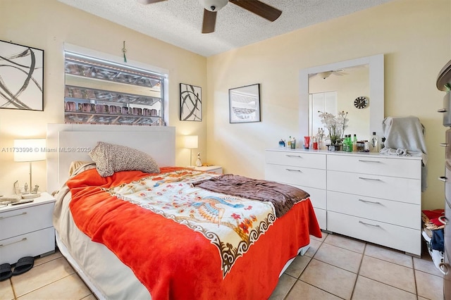 tiled bedroom with a textured ceiling and ceiling fan