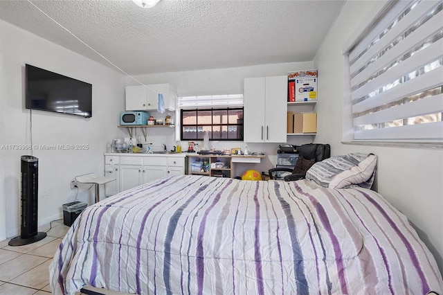 tiled bedroom with a textured ceiling