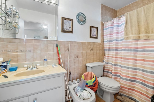 bathroom featuring vanity, tile walls, walk in shower, and toilet