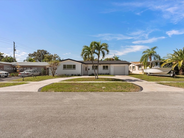 ranch-style home featuring a garage and a front lawn