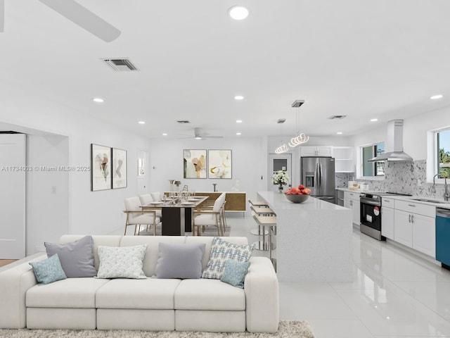 living room with sink and ceiling fan