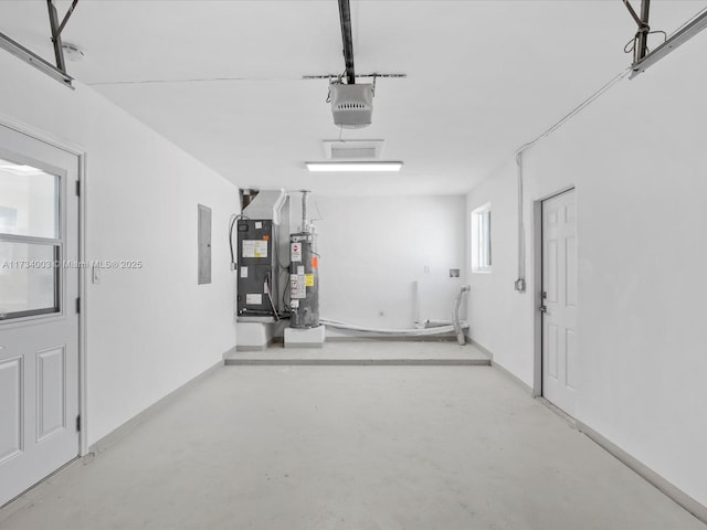 garage featuring a garage door opener, gas water heater, heating unit, and electric panel